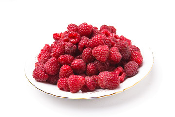 Fresh raspberries lying on a white plate