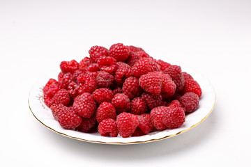 Fresh raspberries lying on a white plate