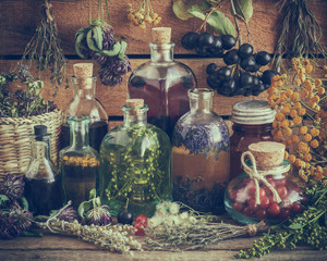 Bottles of tincture, potion, oil, healthy berries and herbs