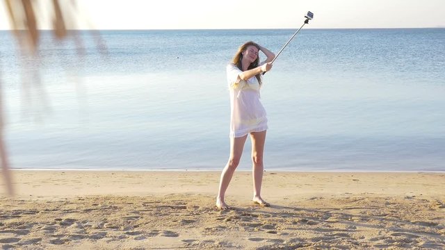 Happy girl making a selfie near the sea. HD