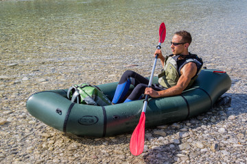 Athletic man packrafting © nidafoto