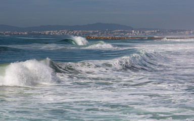 Waves in Costa de Caparica. Summer day in Almada, Portugal.