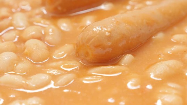 White bean stew with sausages tasty meal on plate close-up 4K 2160p 30fps UltraHD tilting footage - Pearl haricot bean cooked with pork sausages slow tilt 4K 3840X2160 UHD video