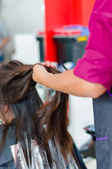 Naklejka premium Hair on dyeing process, a person preparing the rest of the hair to be cut