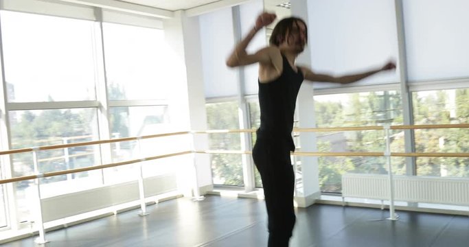 Dancing man modern ballet dancer performs dance in studio