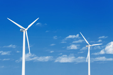 Fototapeta premium Energy windmill produce energy on blue sky at daytime