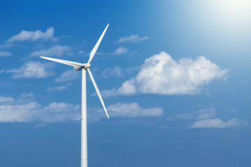 Fototapeta premium Energy windmill produce energy on blue sky at daytime