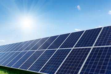 Solar panels generate power energy on blue sky at daytime
