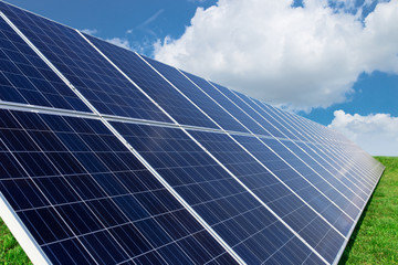 Obraz premium Solar panels generate power energy on blue sky at daytime