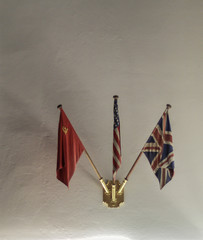 Flags of UNITED STATES OF AMERICA, RUSSIA and UNITED KINGDOM inside the historical Cecilienhof Palace Schloss is a palace in Potsdam, Brandenburg, Germany 