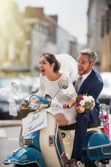  Newlyweds having fun on a decorated vintage scooter © jackfrog