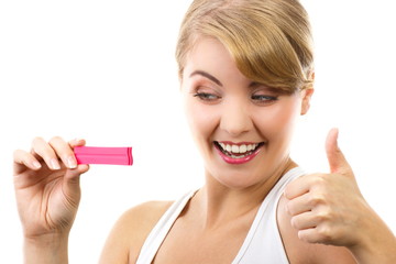 Happy delighted woman looking at pregnancy test with positive result and showing thumbs up, checking pregnancy test, expecting for baby