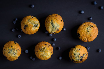 Homemade muffins with strawberries on the wooden background © maxandrew