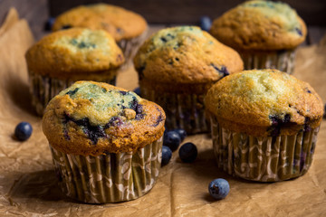 Homemade muffins with strawberries on the wooden background. Selective focus.