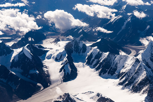 Fototapeta Snow capped mountains range with a bird's-eye view, Leh, Ladakh, India. Aerial view on earth from the window of a flying plane.
