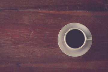 Retro style or Vintage Style, Black Coffee cup Put on a stump or wood table in the garden sunny morning.
