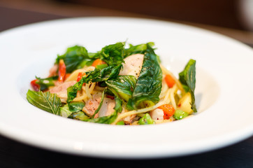 The spaghetti mixed with stir-fried spicy fish. Aromatic spices taste