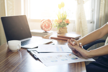 Business woman working with stress at office with laptop and doc