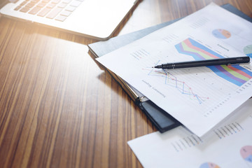 Functional devices, laptop and business data on the table.