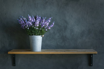 Beautiful violet Flower in zinc bucket no the wood floor and cem