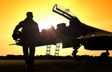 Military pilot on airfield walking away from the fighter jet - obrazy, fototapety, plakaty