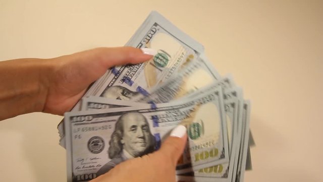business and finance. money counting US dollar notes with par value of $ 100