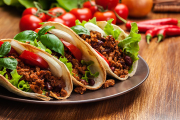 Mexican tacos with minced meat, beans and spices - 120148171