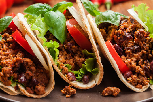 Mexican tacos with minced meat, beans and spices