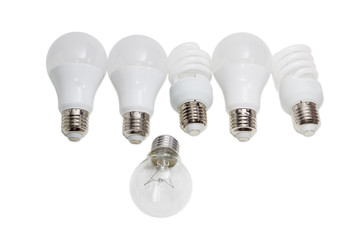 Incandescent lamp against several modern energy saving electric lamps