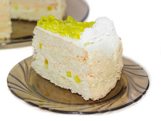 Layered cake with slices of lemon jelly on glass saucer
