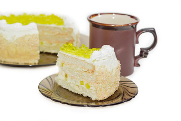Layered cake with slices of lemon jelly on glass saucer