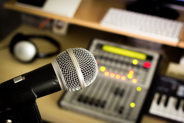 dynamic microphone on digital studio mixer background for music recording, radio / tv broadcasting concept