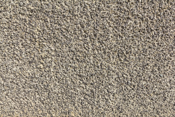 Crushed gravel in cement wall plastered texture