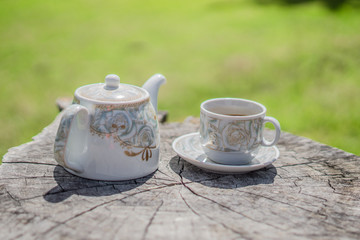 Retro style or Vintage Style,  Coffee cup Put on a stump or wood table in the garden sunny morning.