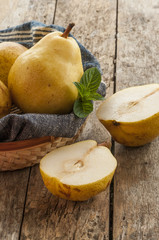 Naklejka na ściany i meble fresh ripe organic pears on a rustic wooden table
