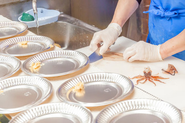 A chef preparing squid sashimi from super fresh material in Hako