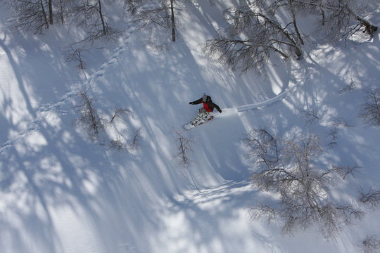 Snowboarder Rides Down the Snowy Mountain Terrain at the Ski Resort at Nevados De Chilean, Chile in the Andes Mountains