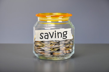 Saving concept of coins in the glass jar for saving purpose
