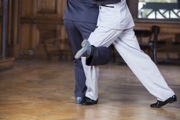 Tango Dancers Performing Gancho Step In Restaurant