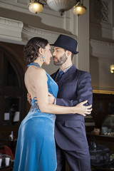 Confident Tango Dancers Embracing In Cafe