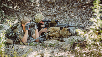 Army sniper during the military operation in the mountain. war,