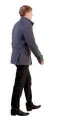 Back view of going  young business man in gray coat.  walking young businessman . Rear view people collection.  backside view of person.  Isolated over white background.