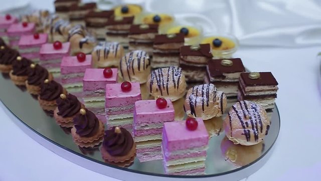 delicious decorated candy bar, sweets on tables for wedding reception