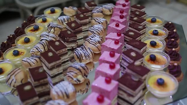 delicious decorated candy bar, sweets on tables for wedding reception