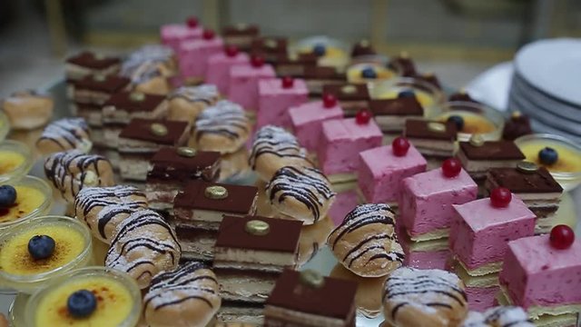 delicious decorated candy bar, sweets on tables for wedding reception