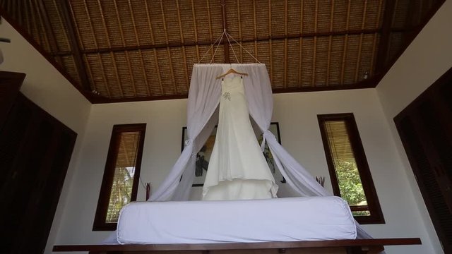 Wedding Dress Hanging Above The Bed
