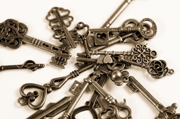 Set of keys on white background. Sepia filter applied.