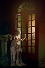 Fototapeta premium Half-naked Victorian lady. Young woman in eighteenth century image posing in vintage interior
