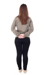 back view of standing young beautiful  woman. girl  watching. Rear view people collection.  backside view of person.  Isolated over white background. Girl standing with hands clasped behind his back.
