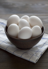 Fresh chicken eggs in bowl on a table.